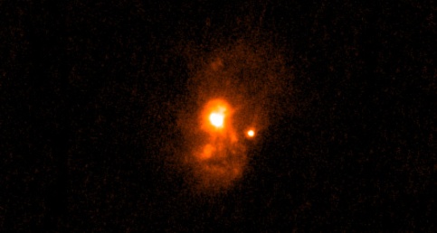 Ultraviolet light (orange) pours out of a galaxy in this image from NASA’s GALEX satellite. New Hubble observations reveal this galaxy might mimic the earliest galaxies in the universe. (Credit: NASA; ESA; R. Overzier/ON/MCT; T. Heckman/JH)